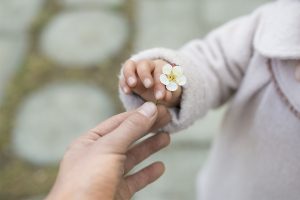 Giving Child a Flower